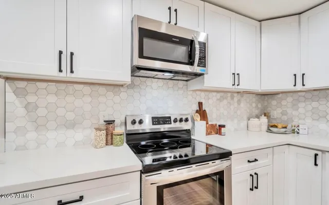 a kitchen with cabinets and appliances