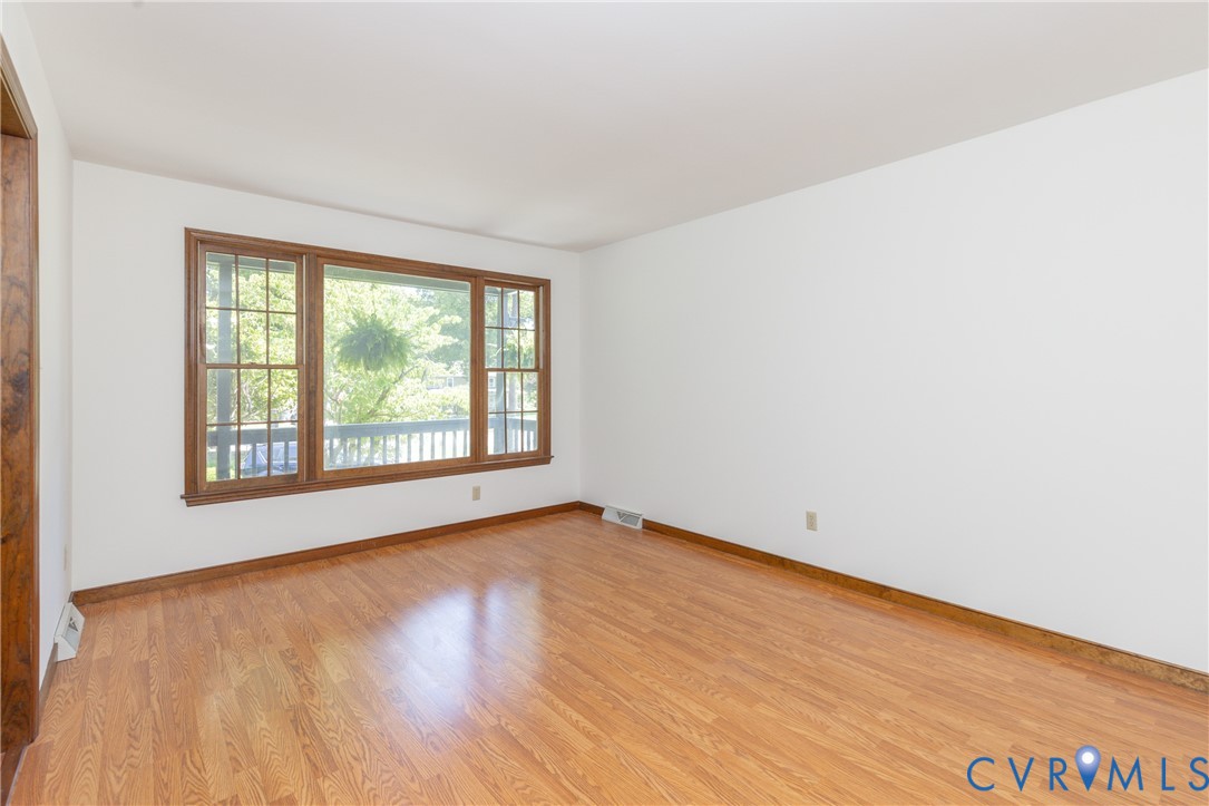 617 Rebel Ridge Road Colonial Heights, VA 23834 - Photo 23 of 49 a view of an empty room with wooden floor and a window