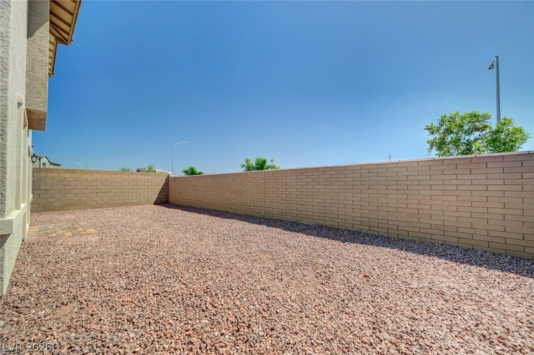 345 Isla Enclave Way Henderson, NV 89011 - Photo 71 of 75 This private yard features durable block fencing and a low-maintenance gravel surface, perfect for outdoor enjoyment.