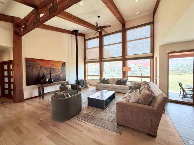 425 Amber Lane Moab, UT 84532 - Photo 4 of 27 Living area with a wood stove, light wood-type flooring, a ceiling fan, and recessed lighting