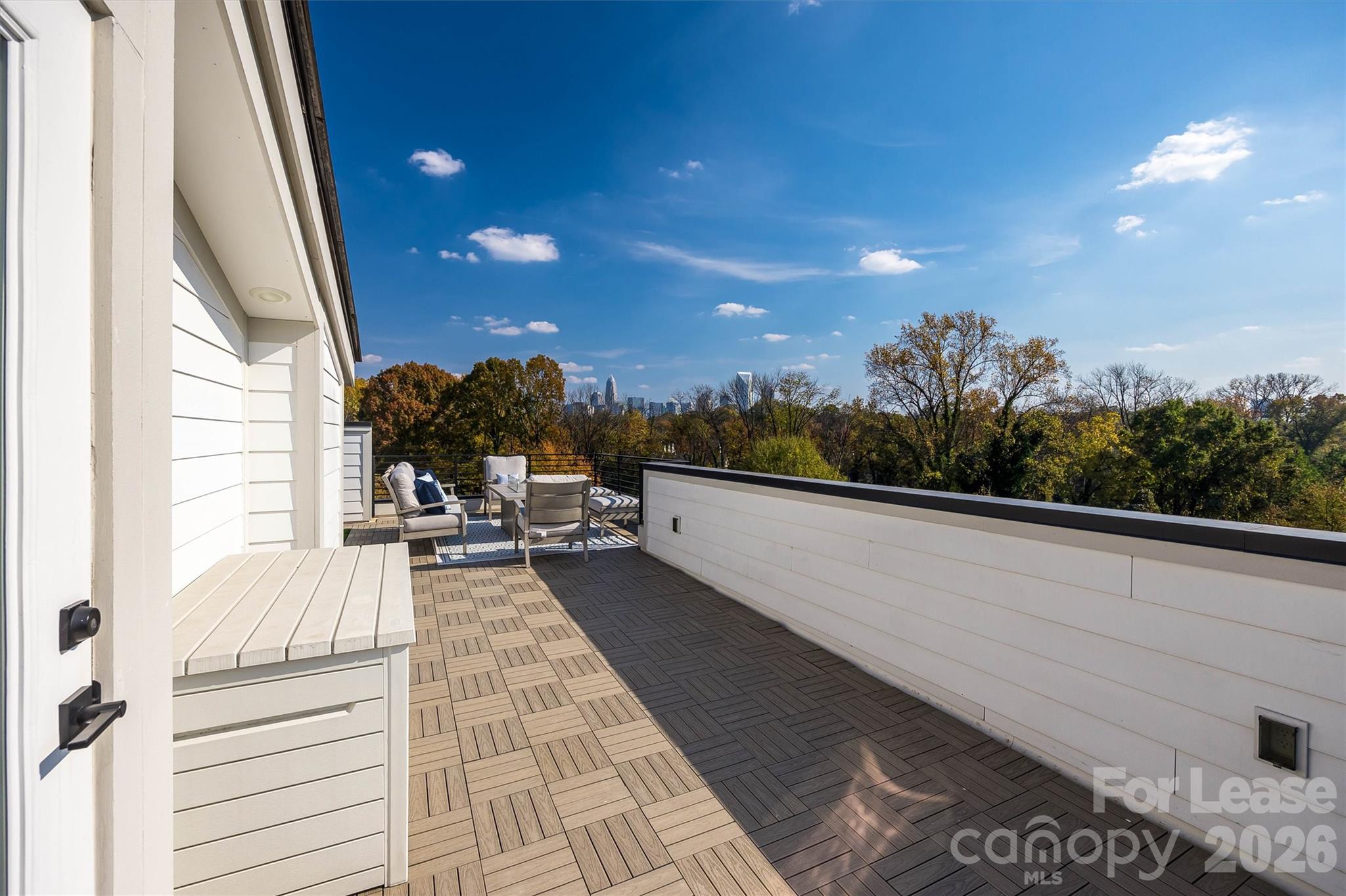 2319 Wesley Village Road Charlotte, NC 28208 - Photo 32 of 44 a view of a balcony with couch and wooden floor