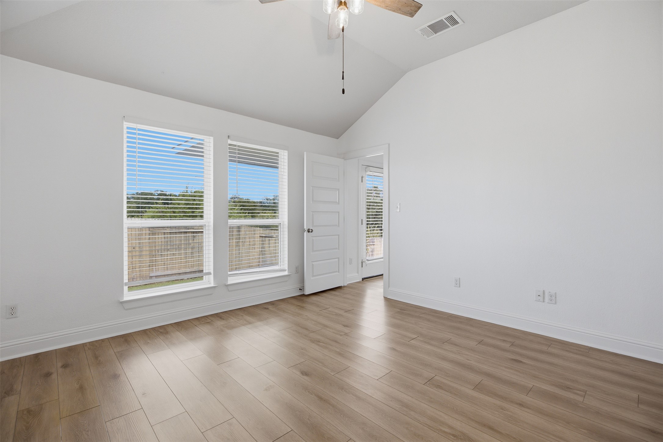 321 Gaida Loop Georgetown, TX 78628 - Photo 18 of 26 Crisp white walls and clean wood floors define this light-filled room with vaulted ceilings.