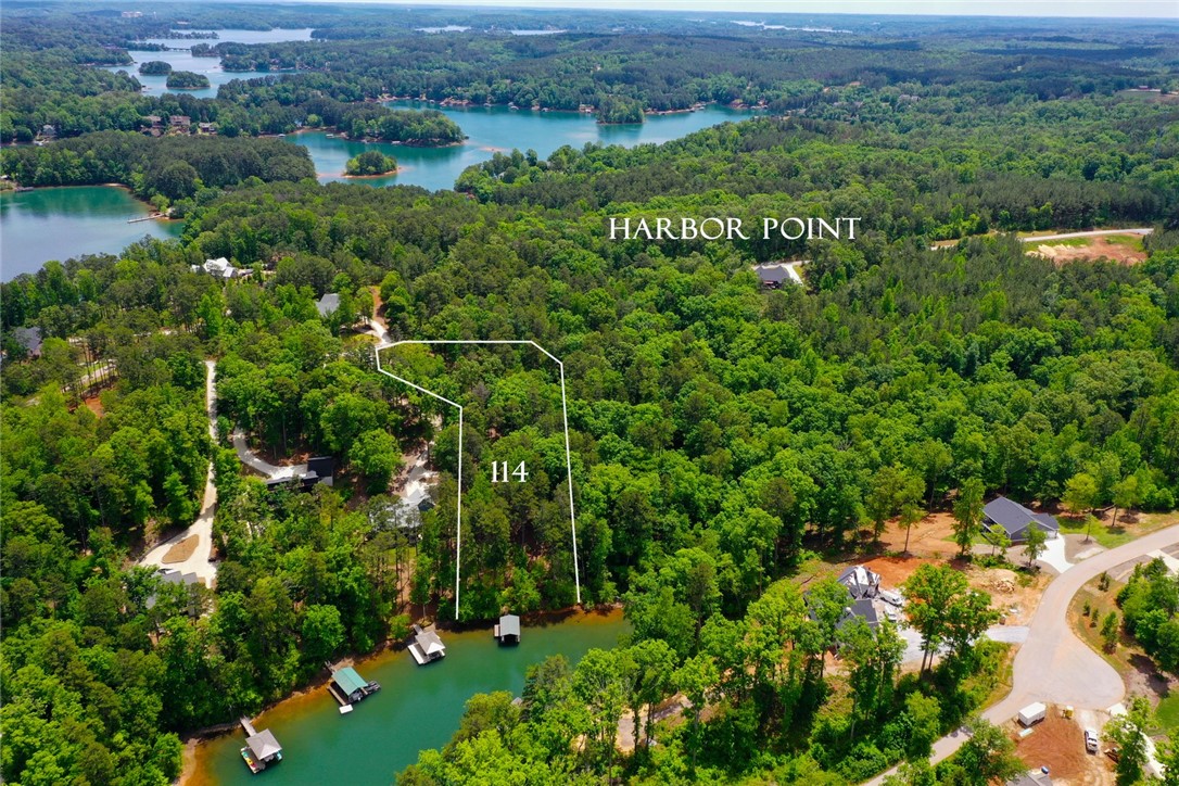 Lot 114 Harbor Point Seneca, SC 29672 - Photo 4 of 46 This aerial view showcases a picturesque waterfront community with lush greenery and tranquil waters.