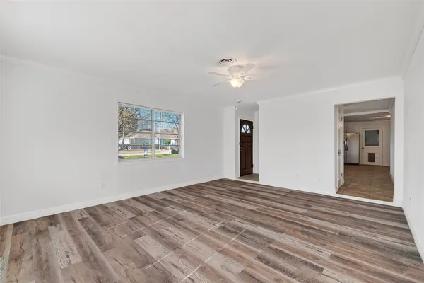 wooden floor in an empty room with a window