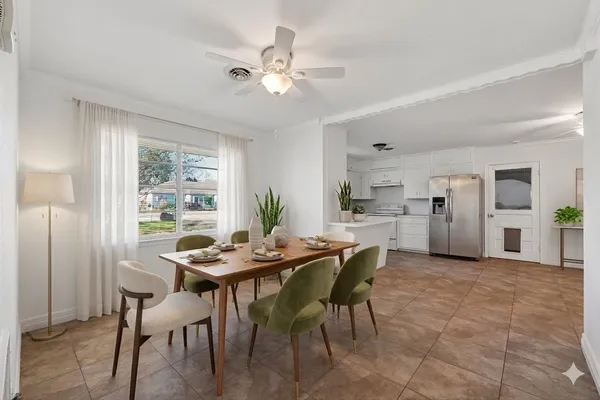 a view of a kitchen with furniture and chandelier fan