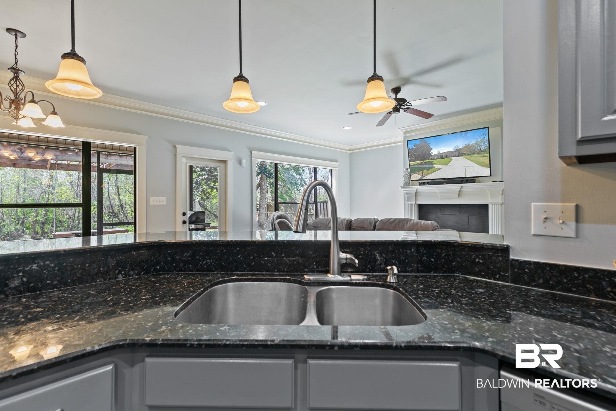9584 Sanibel Loop Daphne, AL 36526 - Photo 48 of 48 Kitchen featuring open floor plan, dark stone counters, crown molding, gray cabinetry, and a ceiling fan
