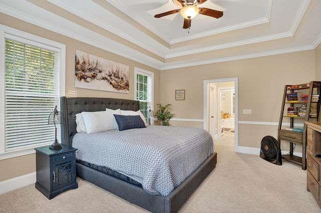 8179 Pineview Court Villa Rica, GA 30180 - Photo 15 of 41 a bedroom with a bed and a chandelier