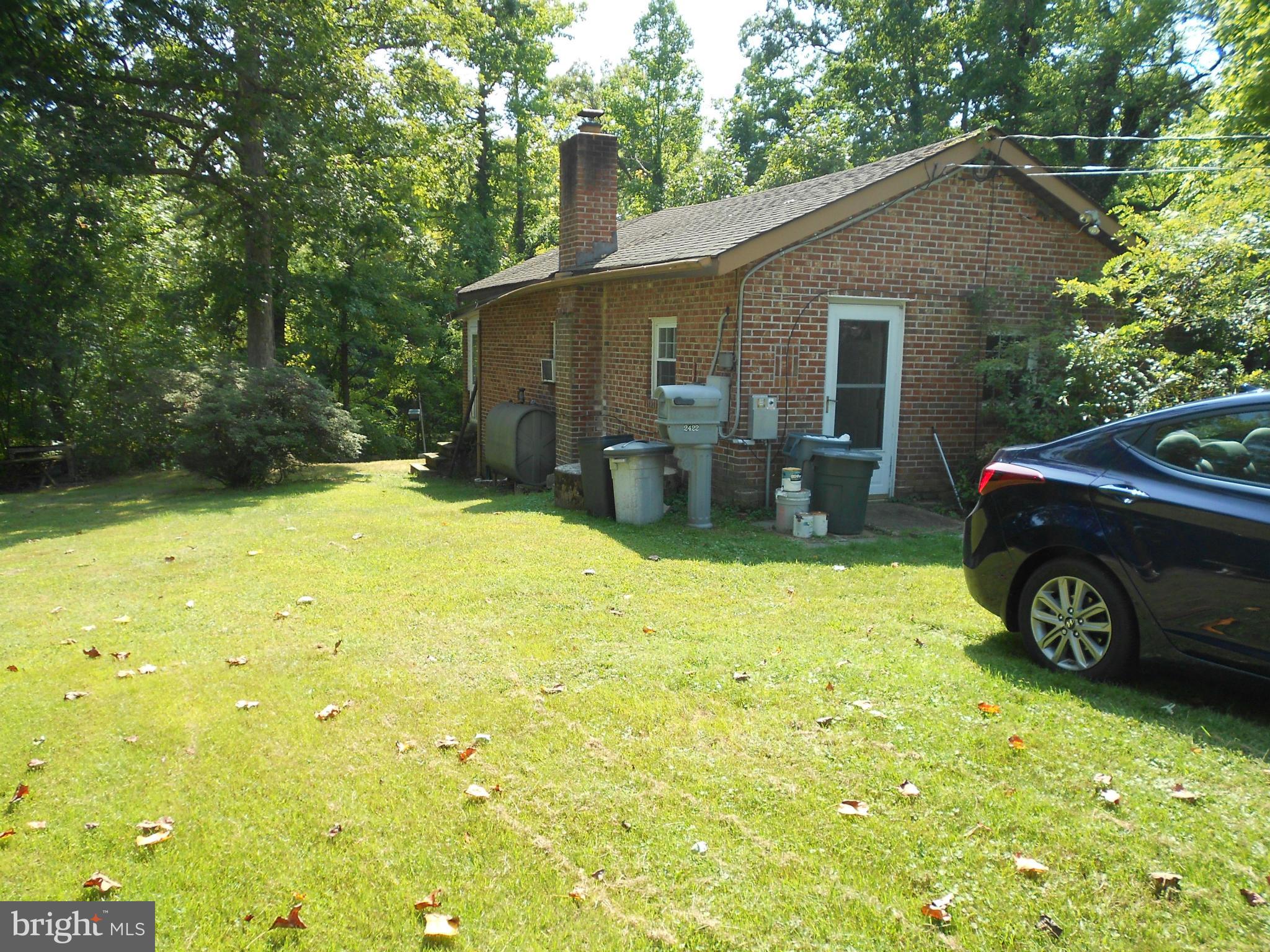 2422 Poplar Road Essex, MD 21221 - Photo 1 of 9 a view of a house with backyard patio and sitting area