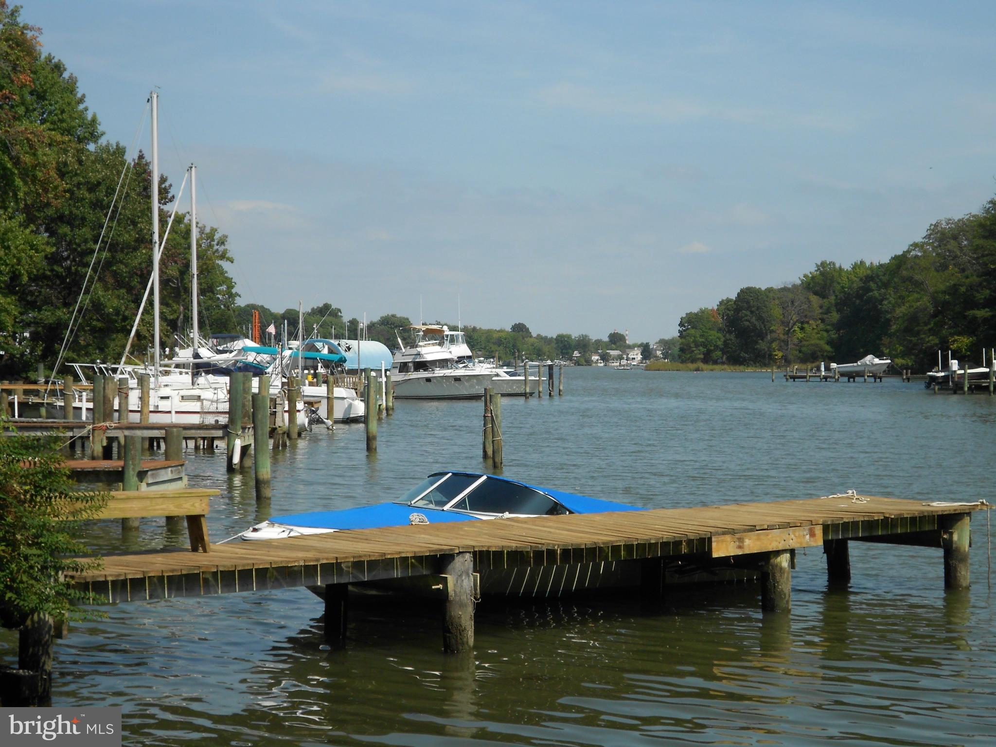 2422 Poplar Road Essex, MD 21221 - Photo 8 of 9 a view of a lake with boats and trees in the background