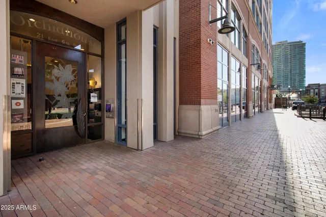 a view of a city from a hallway with a outdoor seating