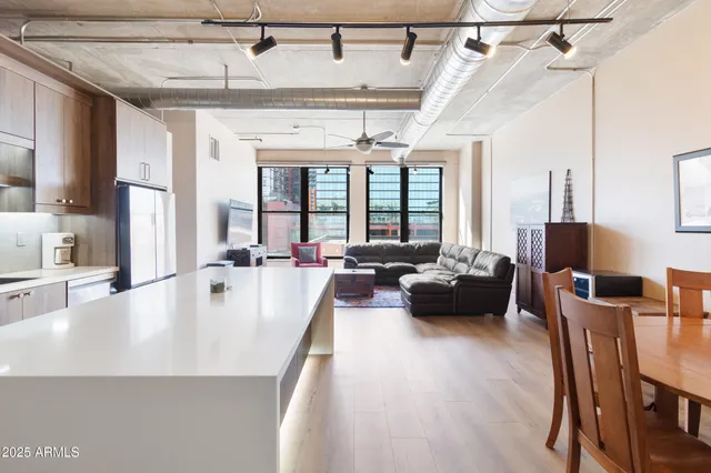 a view of a dining room with furniture a chandelier and wooden floor