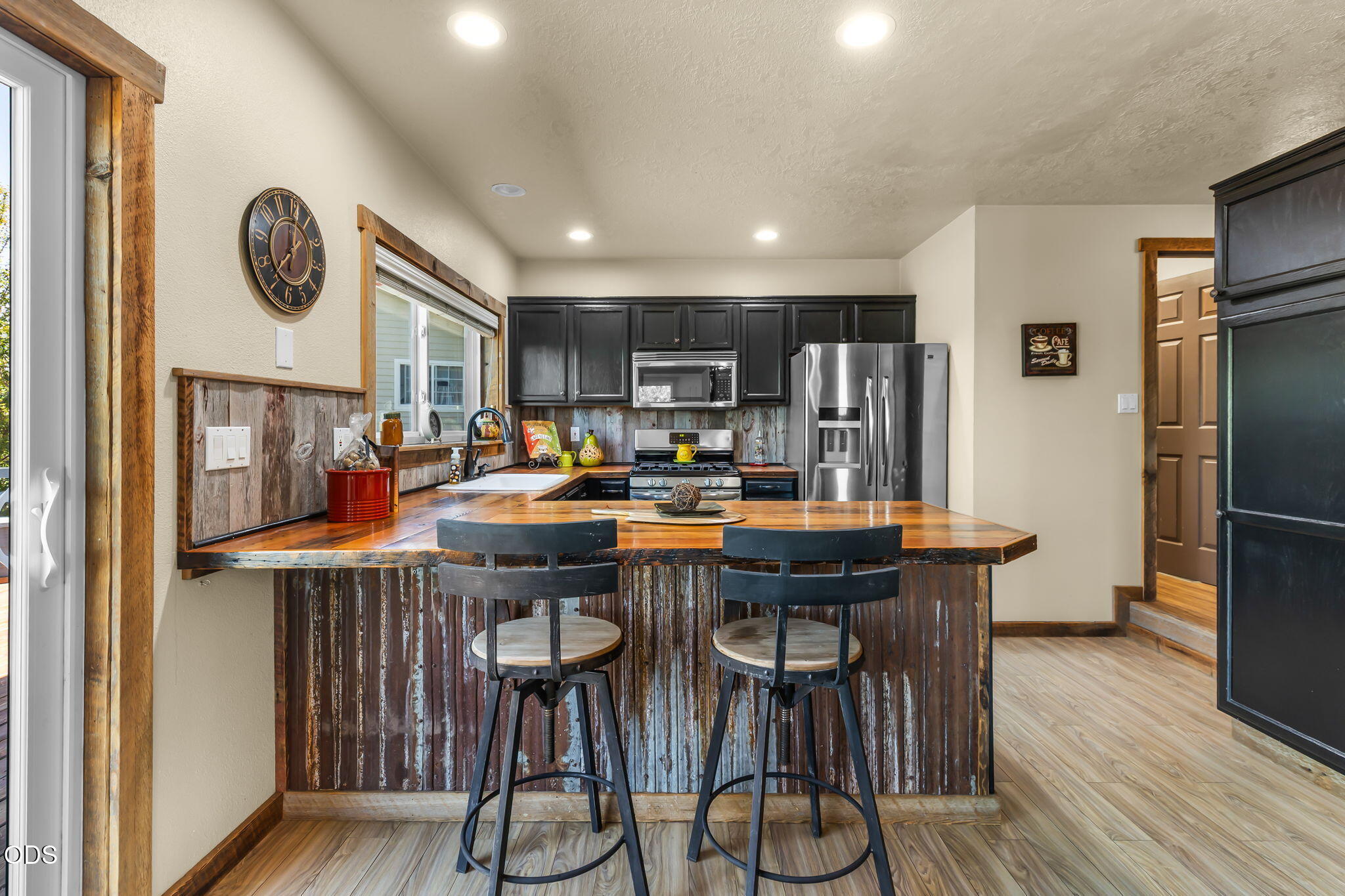 2486 Southwest Valleyview Drive Redmond, OR 97756 - Photo 8 of 55 a dining hall with stainless steel appliances granite countertop a table chairs a stove and a refrigerator