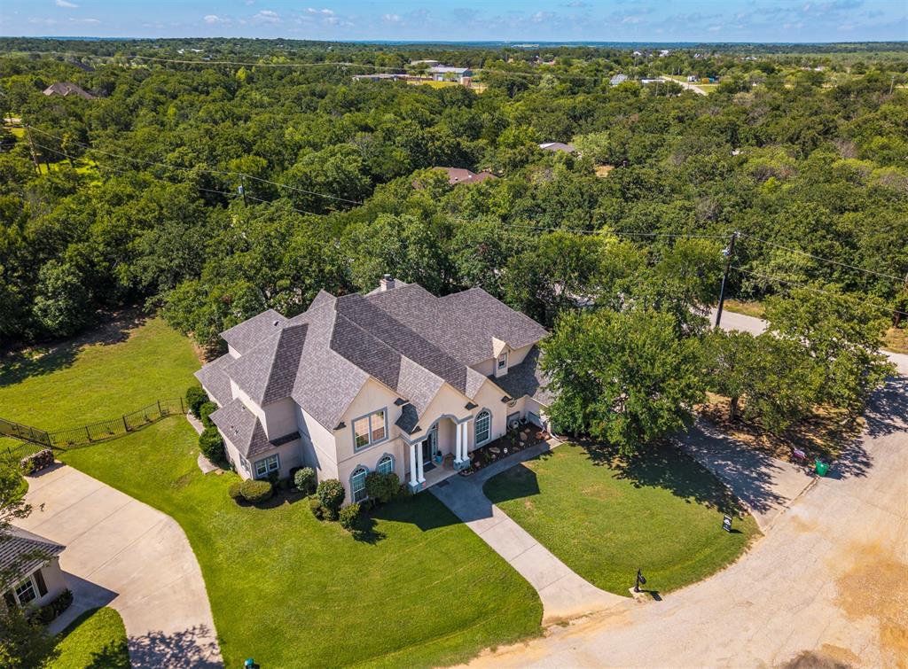 100 Manders Court Runaway Bay, TX 76426 - Photo 1 of 33 an aerial view of a house with yard swimming pool and outdoor seating