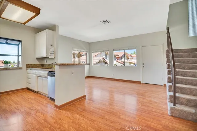 a view of kitchen with wooden floor and electronic appliances