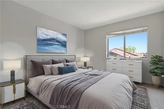 a bedroom with a bed and a painting on the wall