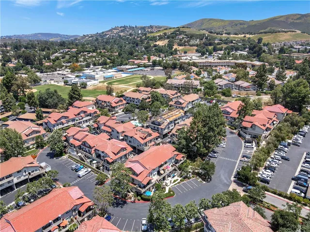 an aerial view of residential houses with outdoor space