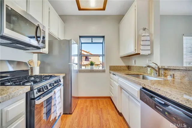 a kitchen with stainless steel appliances granite countertop a stove and a sink