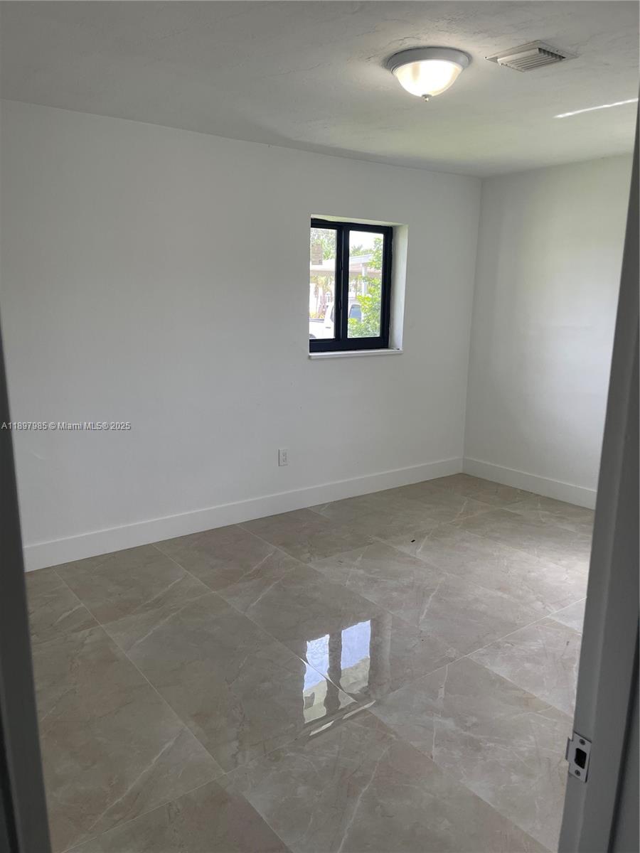 4310 Northwest 182nd Street Miami Gardens, FL 33055 - Photo 11 of 12 an empty room with a empty space and window