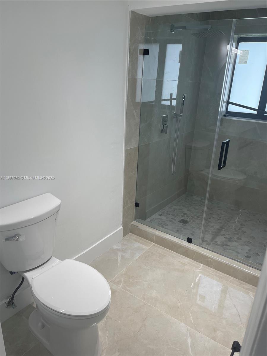 4310 Northwest 182nd Street Miami Gardens, FL 33055 - Photo 12 of 12 a bathroom with a toilet and a shower