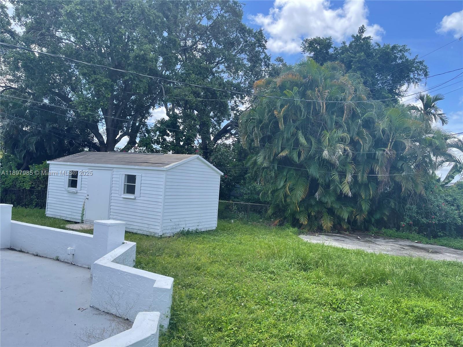 4310 Northwest 182nd Street Miami Gardens, FL 33055 - Photo 9 of 12 a view of a house with a yard and tree s