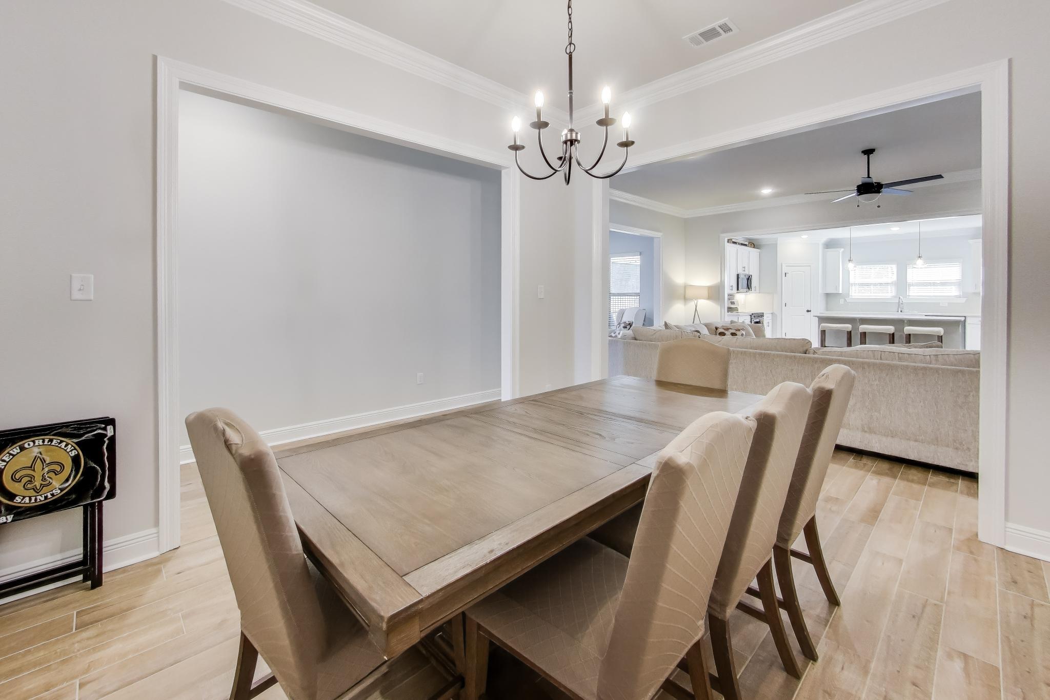 46 East Tweet Street Freeport, FL 32439 - Photo 12 of 59 a view of a dining room with furniture and wooden floor