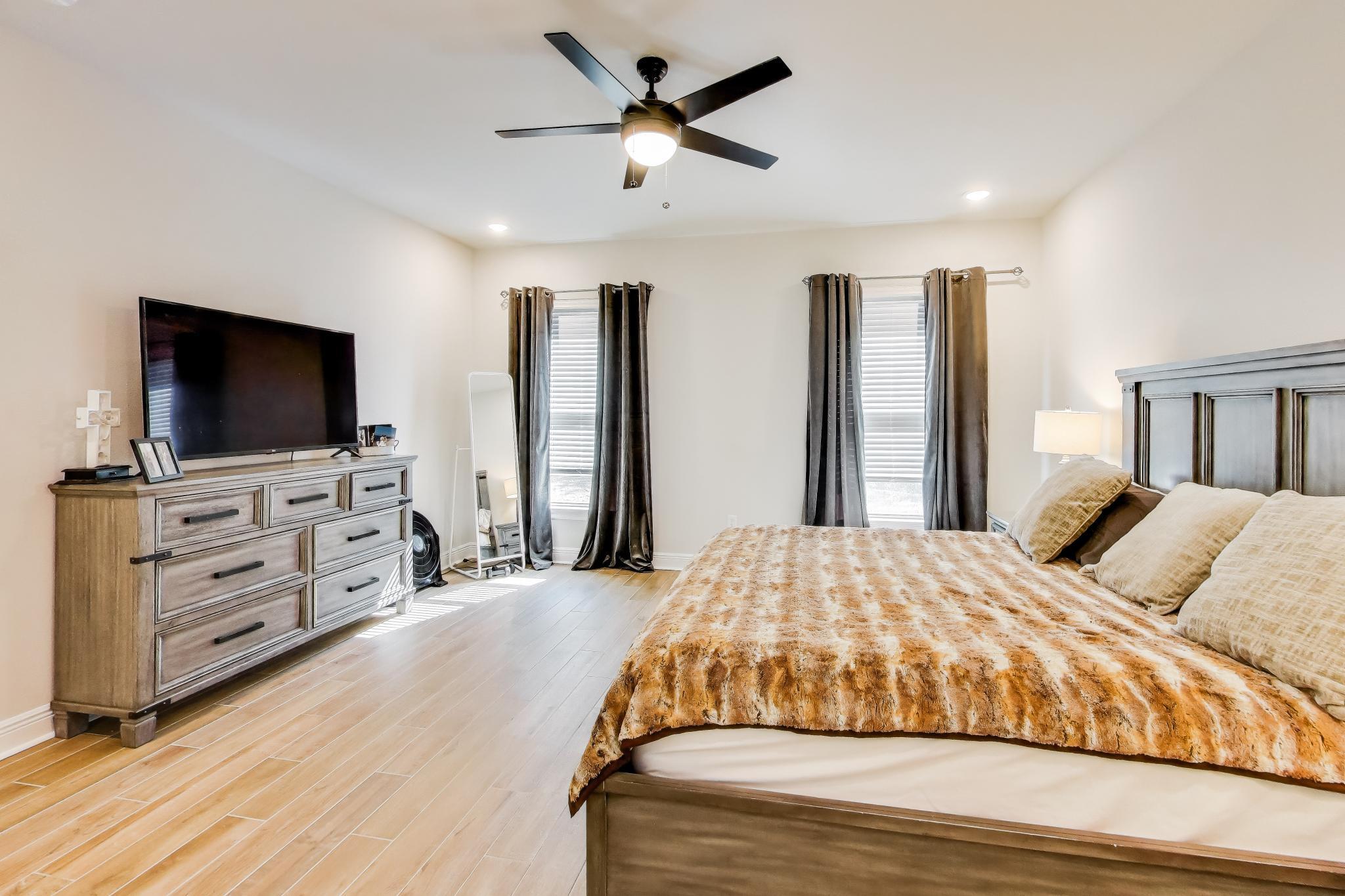 46 East Tweet Street Freeport, FL 32439 - Photo 18 of 59 a bedroom with a bed and a flat screen tv