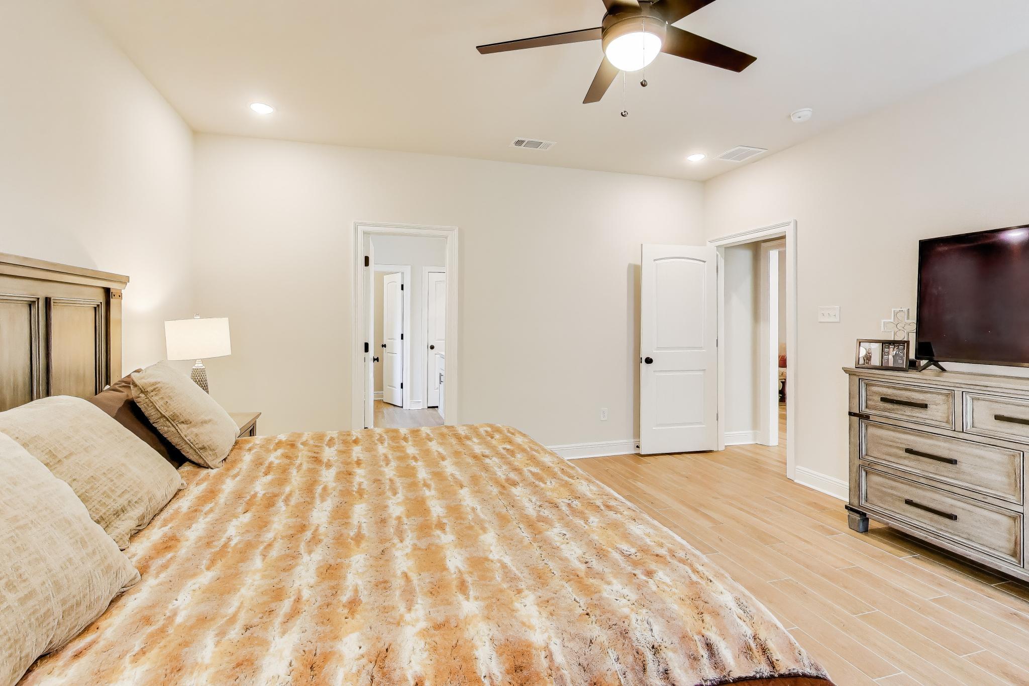 46 East Tweet Street Freeport, FL 32439 - Photo 19 of 59 a bedroom with a bed and a flat screen tv