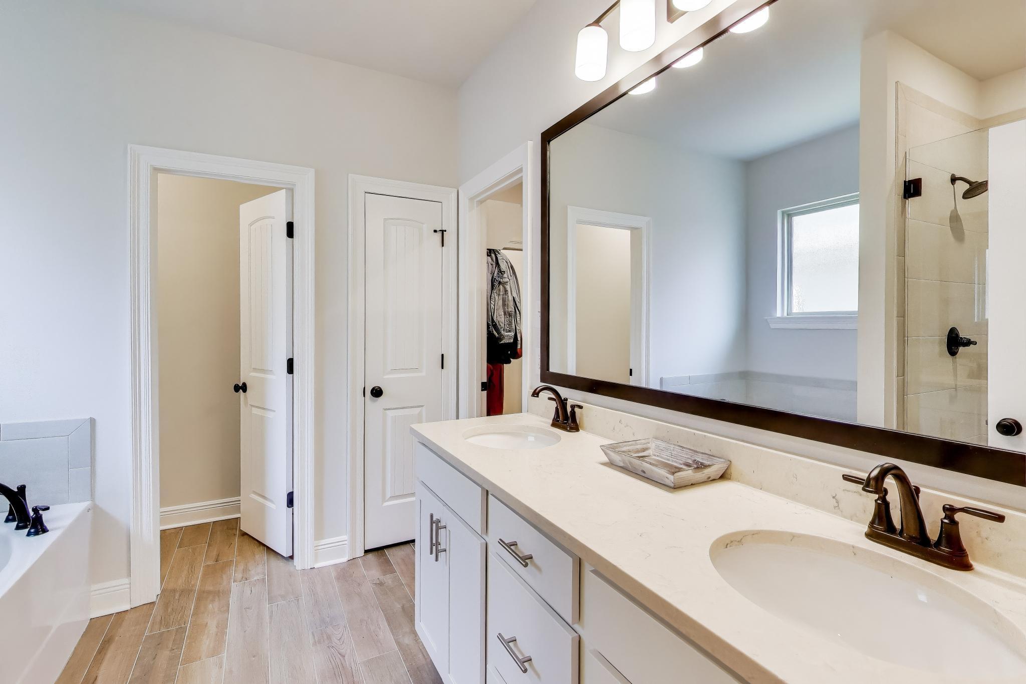 46 East Tweet Street Freeport, FL 32439 - Photo 20 of 59 a bathroom with a sink double vanity granite tub and shower