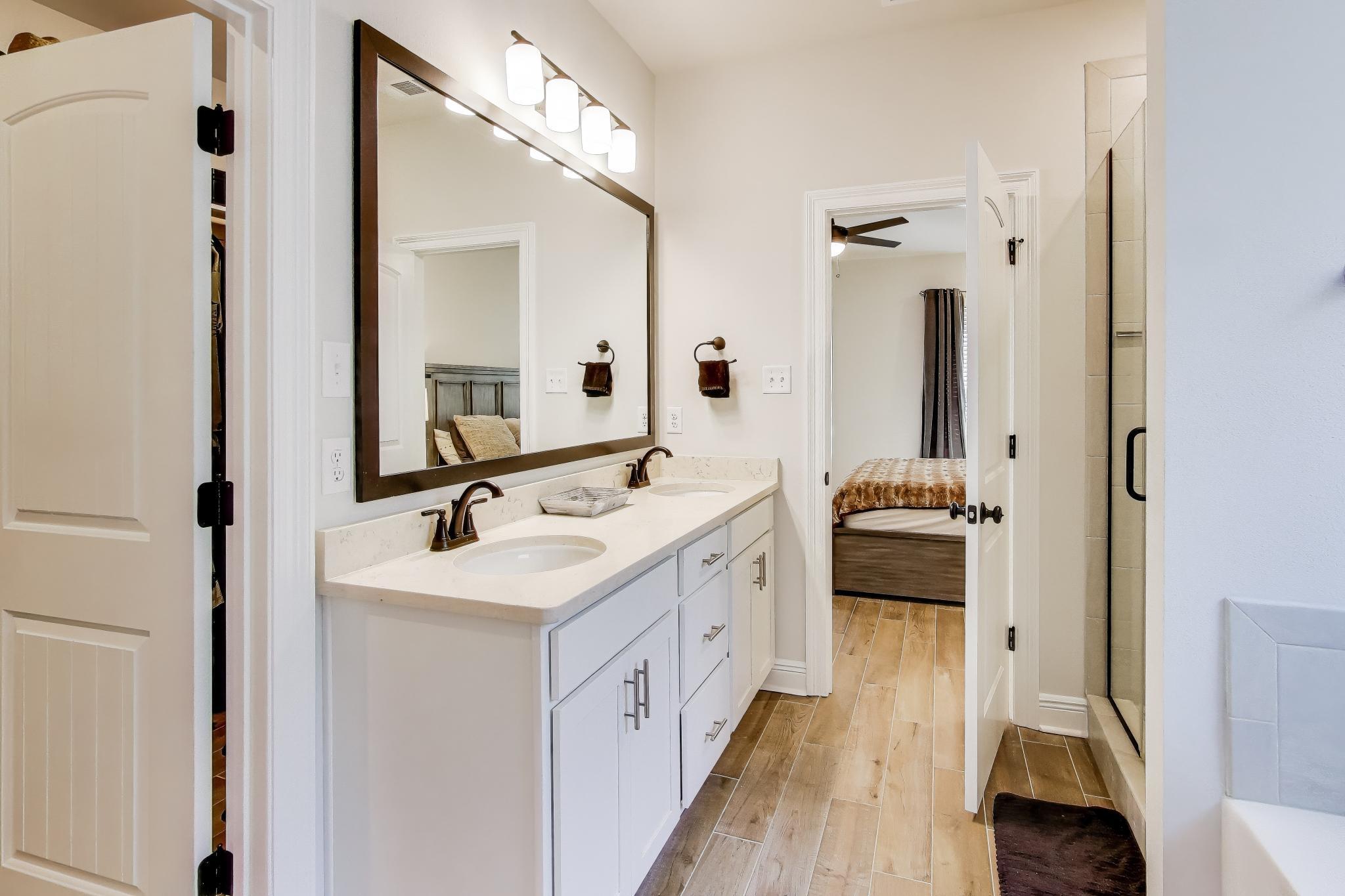 46 East Tweet Street Freeport, FL 32439 - Photo 21 of 59 a en suite bathroom with a double vanity sink and a mirror