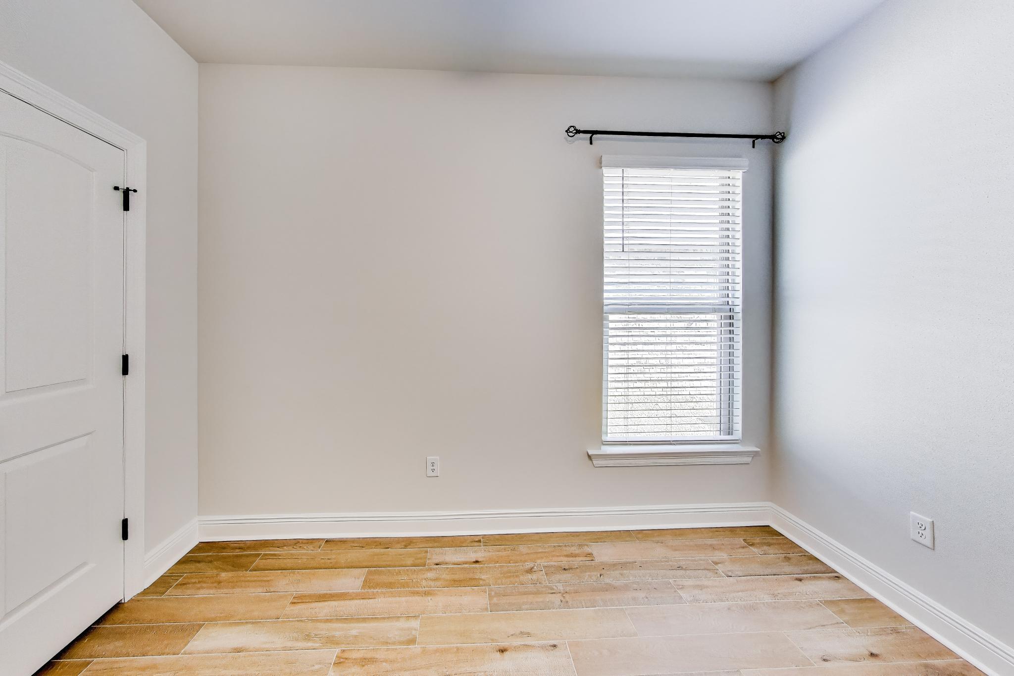 46 East Tweet Street Freeport, FL 32439 - Photo 30 of 59 a view of an empty room with wooden floor and a window