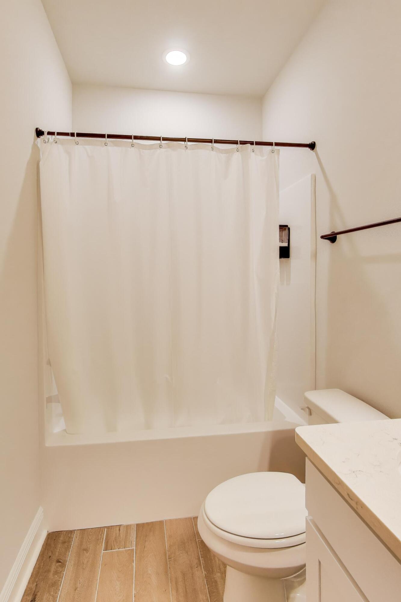 46 East Tweet Street Freeport, FL 32439 - Photo 34 of 59 a white toilet sitting next to a bathroom sink and a shower