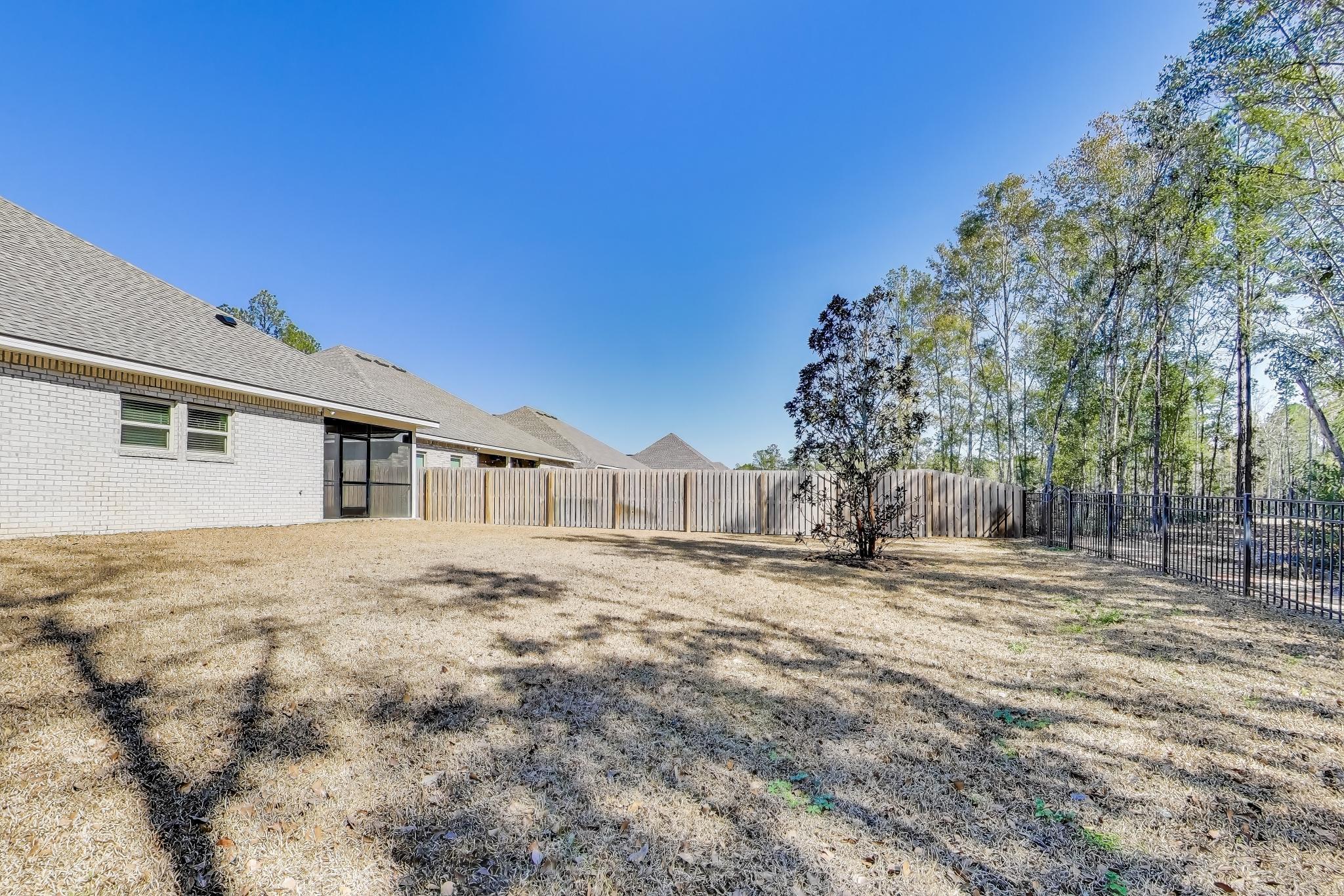 46 East Tweet Street Freeport, FL 32439 - Photo 42 of 59 a big house with large trees and a big yard