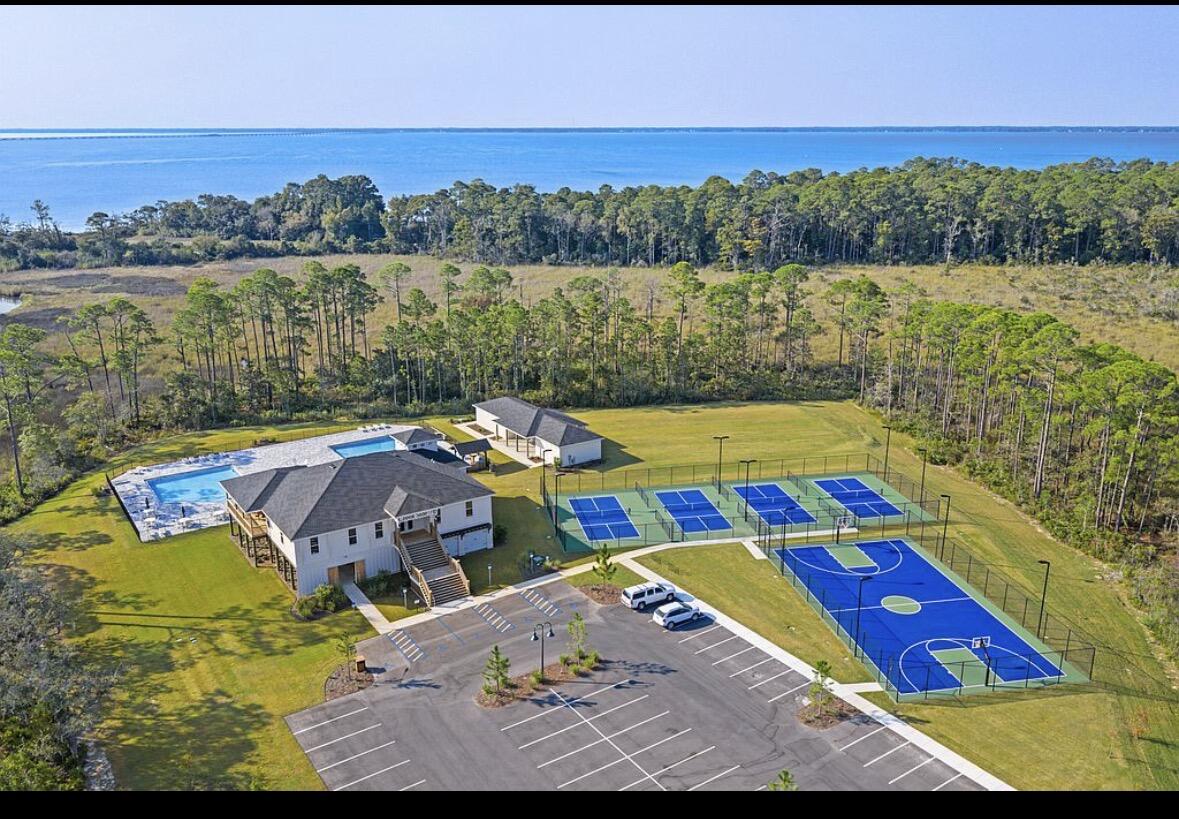 46 East Tweet Street Freeport, FL 32439 - Photo 52 of 59 a view of swimming pool with a table and chairs under an umbrella