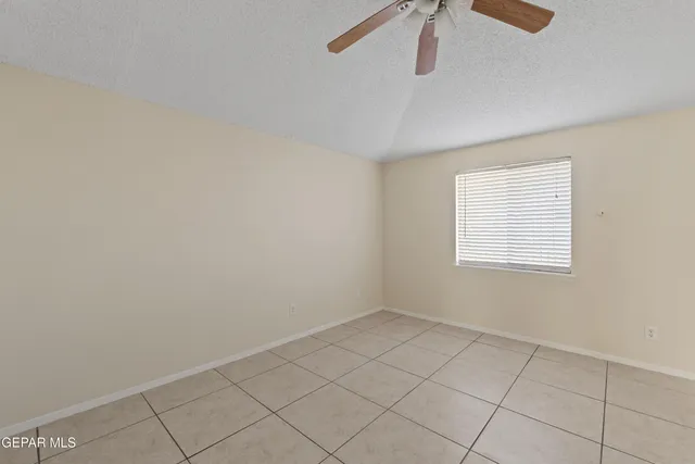a view of backyard with wooden fence