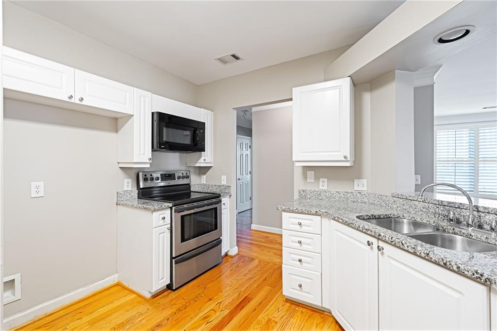 3334 Peachtree Road Northeast, Unit 312 Atlanta, GA 30326 - Photo 11 of 79 a kitchen with stainless steel appliances granite countertop a sink and a stove