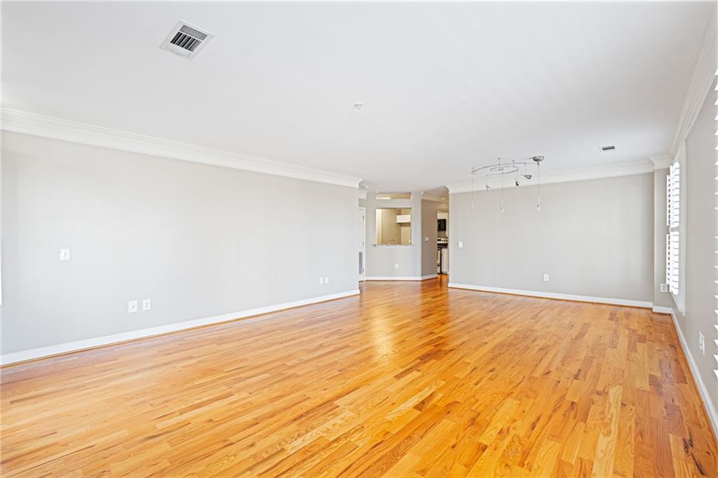 3334 Peachtree Road Northeast, Unit 312 Atlanta, GA 30326 - Photo 14 of 79 a view of empty room with wooden floor and fan