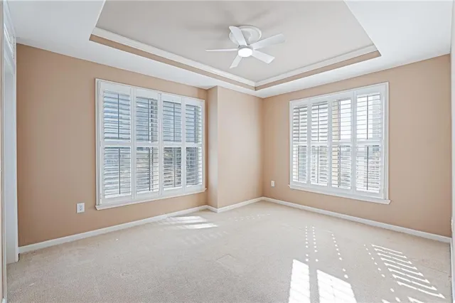a view of a hallway with wooden floor and a bathroom