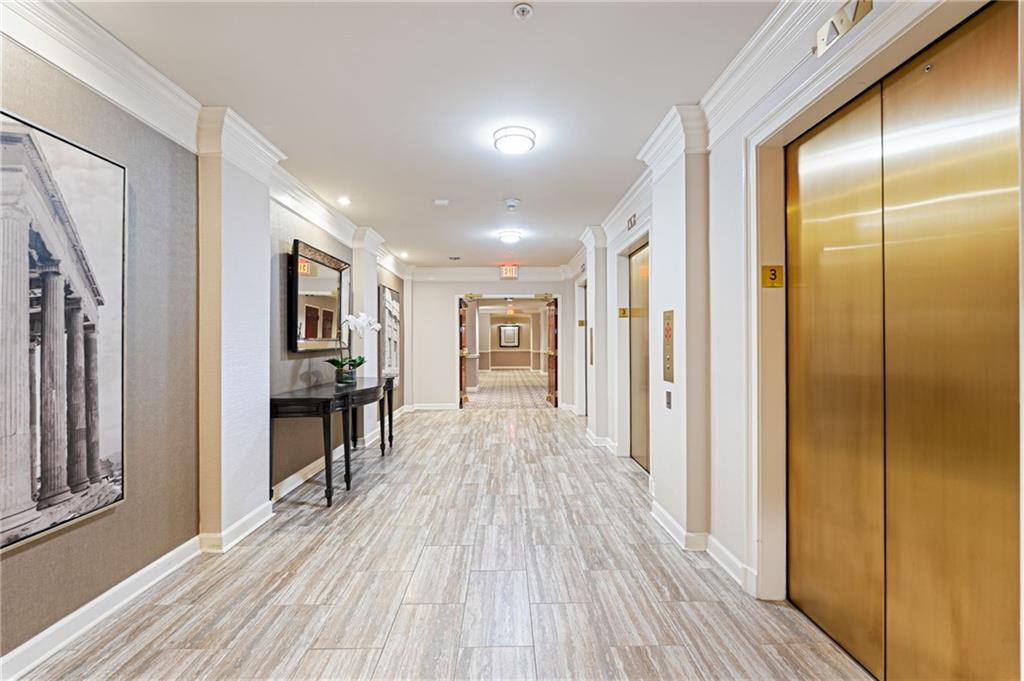 3334 Peachtree Road Northeast, Unit 312 Atlanta, GA 30326 - Photo 27 of 79 a view of a hallway with wooden floor and a bathroom