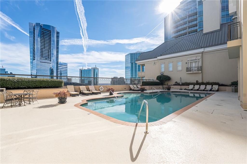 3334 Peachtree Road Northeast, Unit 312 Atlanta, GA 30326 - Photo 29 of 79 a swimming pool with outdoor seating and city view
