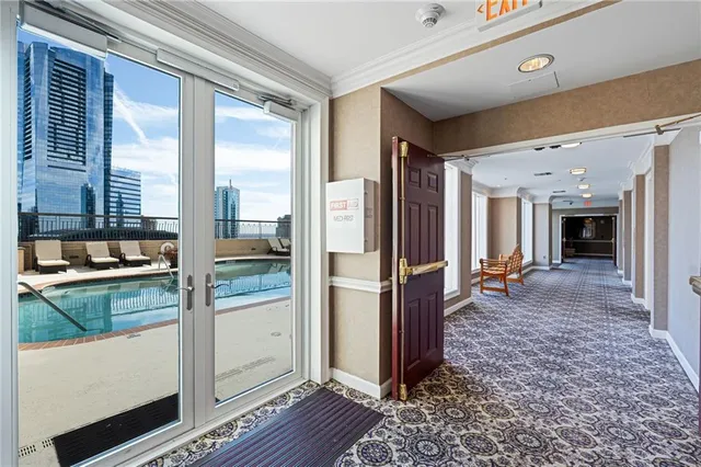 a living room with fireplace furniture and a large window