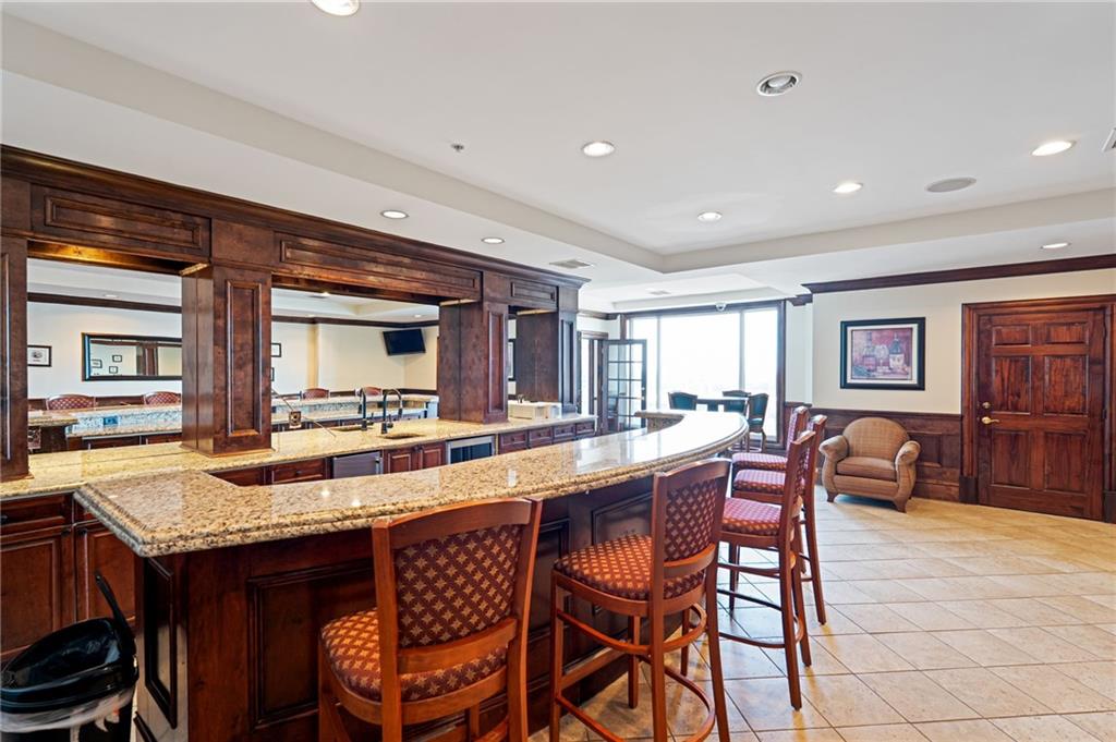3334 Peachtree Road Northeast, Unit 312 Atlanta, GA 30326 - Photo 38 of 79 a dining hall with stainless steel appliances granite countertop a table and chairs