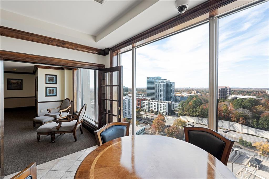 3334 Peachtree Road Northeast, Unit 312 Atlanta, GA 30326 - Photo 39 of 79 a living room with furniture and a floor to ceiling window