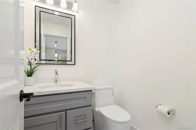 a view of staircase with railing and white walls