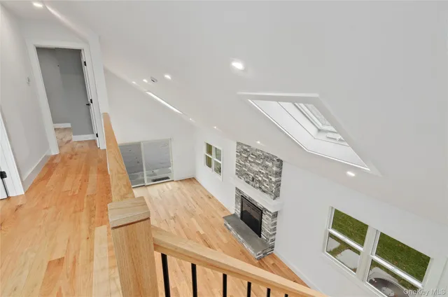 a view of a hallway with furniture and staircase