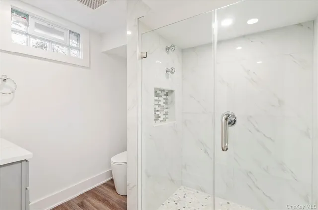 a view of empty room with wooden floor