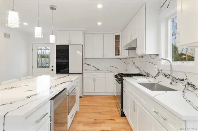 a kitchen with a sink stove and refrigerator