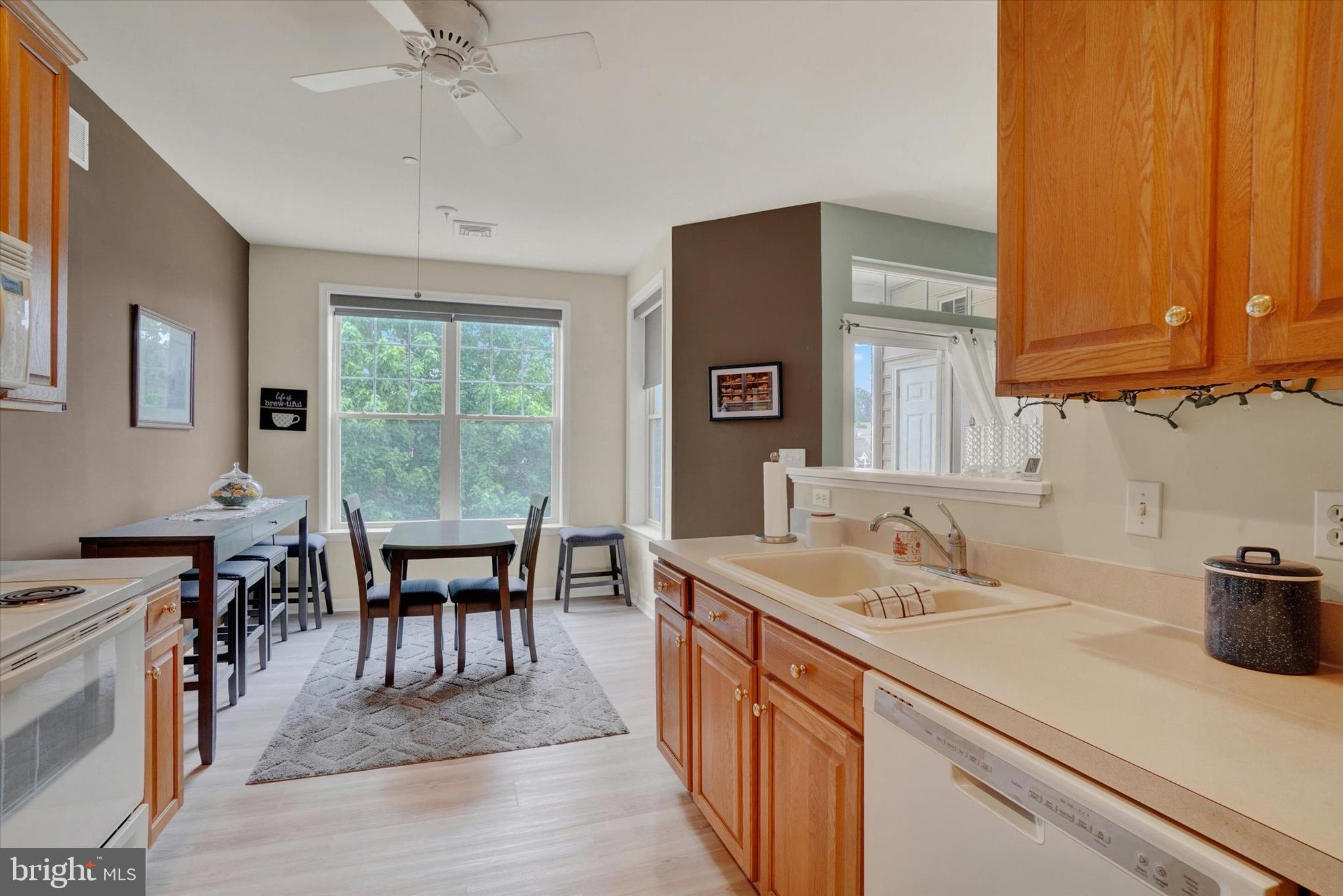 1010 Crest Way, Unit 304 York, PA 17403 - Photo 9 of 24 a kitchen with a sink a stove and chairs
