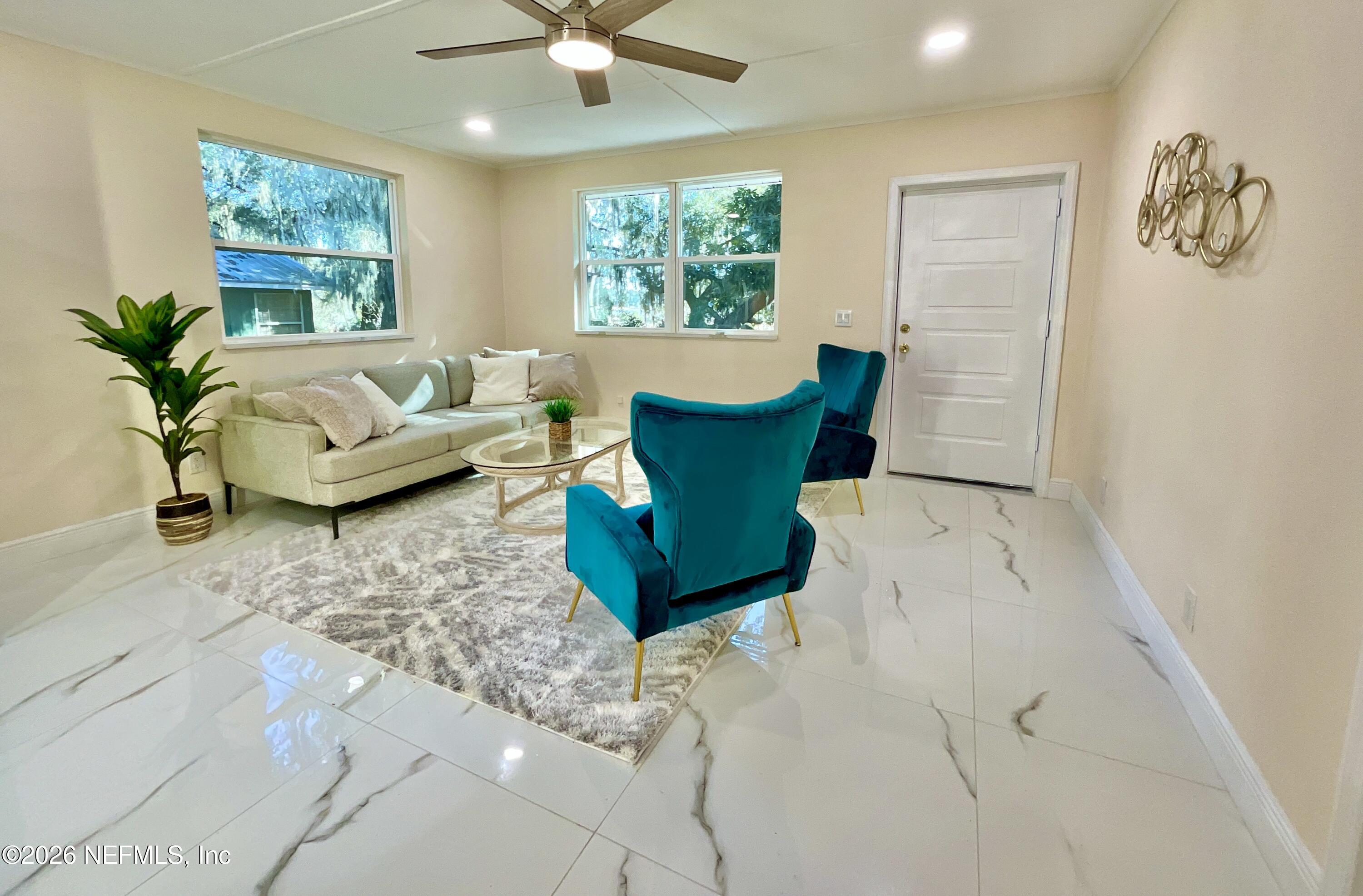 111 2nd Street Melrose, FL 32666 - Photo 12 of 36 a living room with furniture and a large window