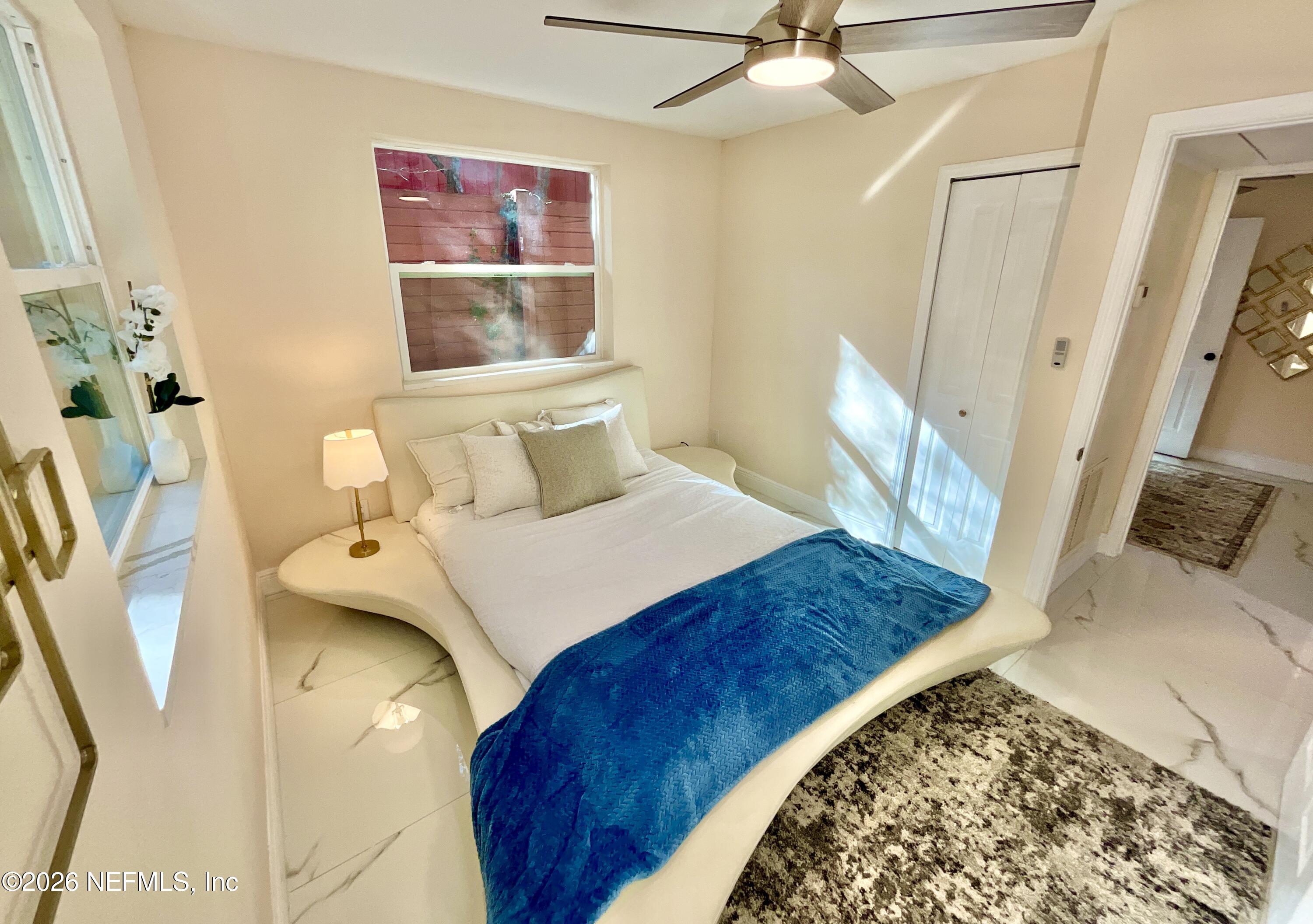 111 2nd Street Melrose, FL 32666 - Photo 14 of 36 a bedroom with a bed and a view of bathroom