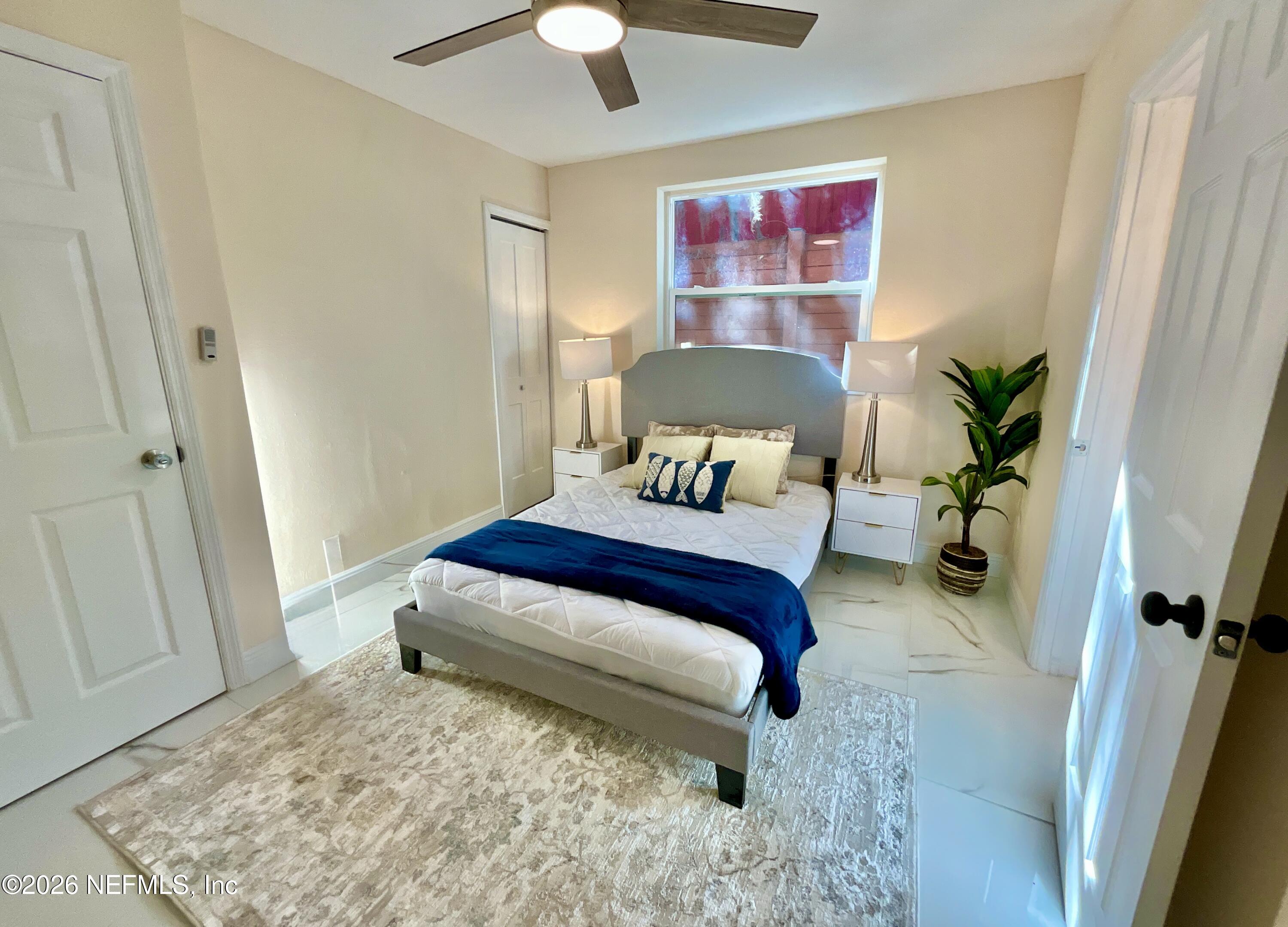 111 2nd Street Melrose, FL 32666 - Photo 16 of 36 a bedroom with a bed and a chandelier